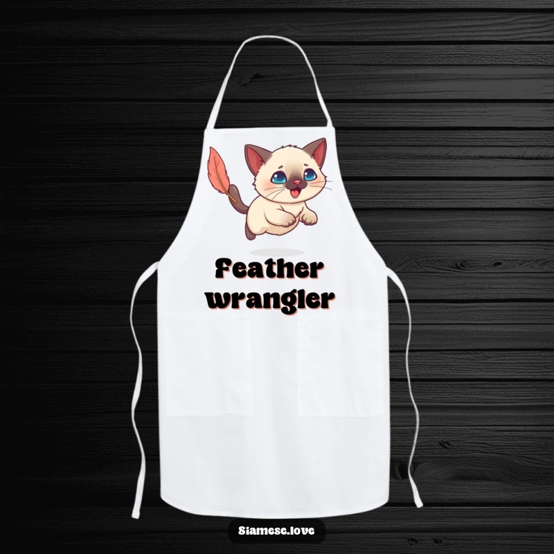 Funny Kawaii Siamese cat ready to pounce on a feather toy, adding humor to kitchen chores on an apron.