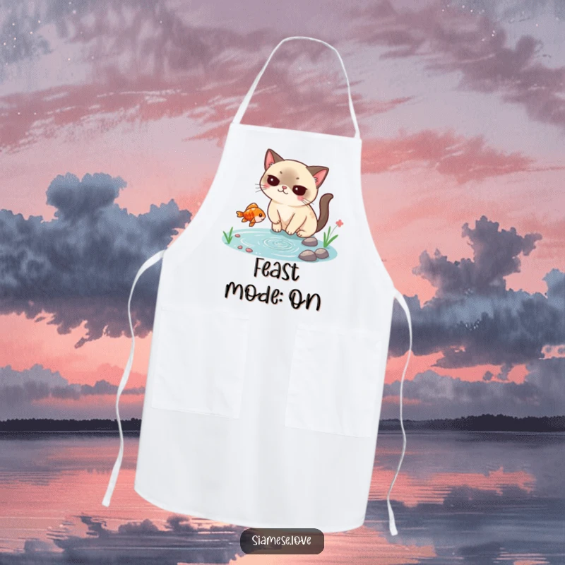 Funny Siamese cat apron, smugly catching a falling fish from a tiny pond, a humorous and practical kitchen accessory for chefs.
