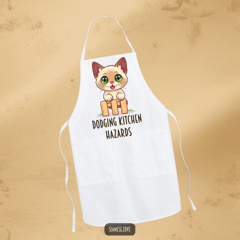Funny Siamese cat apron, a startled cat with bulging eyes is shown jumping over a tiny fence, adding humor to the kitchen.