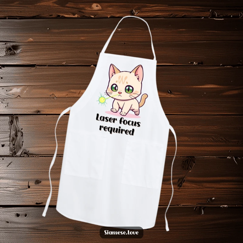 Funny Siamese Cat Apron: A Siamese cat character with startled eyes is comically engaged in chasing a laser dot while cooking.