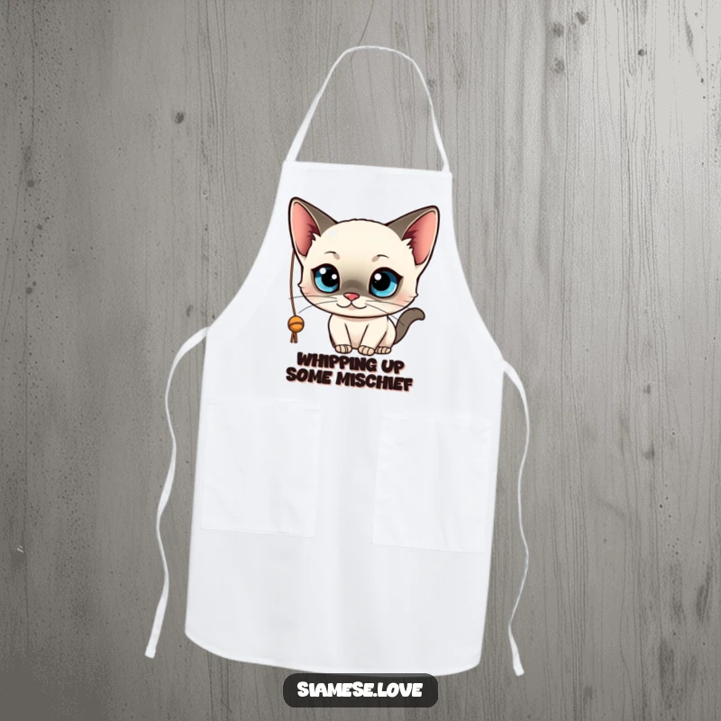 Funny cooking apron showcasing a kawaii Siamese cat with wide blue eyes, playfully batting at a string. Practical and humorous.