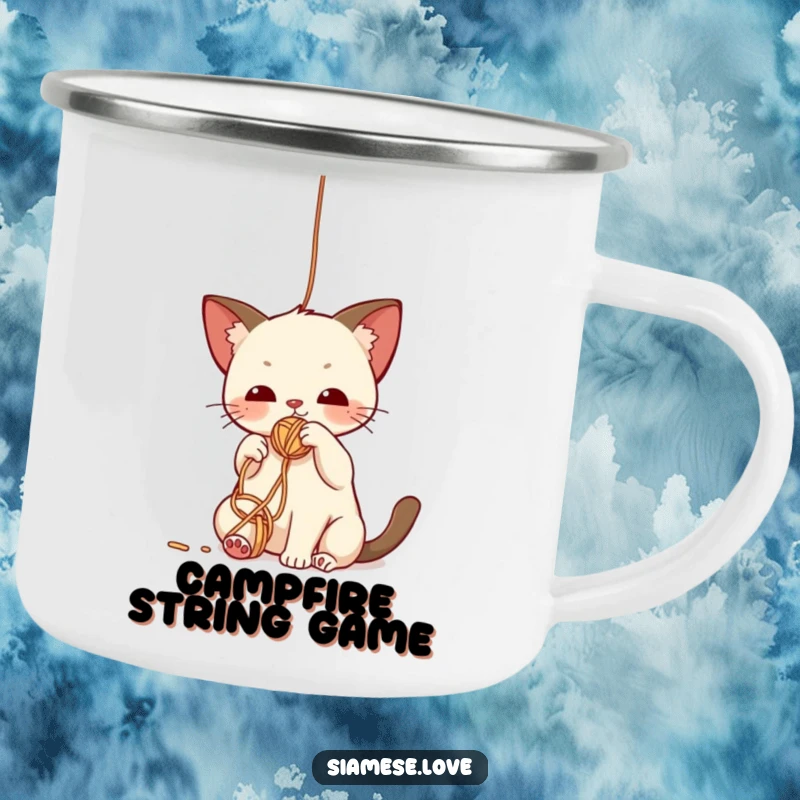 Funny camping mug showcasing a cute kawaii Siamese cat batting playfully at a dangling yarn ball, perfect for feline fun outdoors.