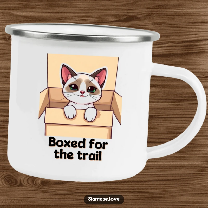 Funny kawaii Siamese cat camping mug, peeking from a box with a mischievous grin, designed for outdoor fun.