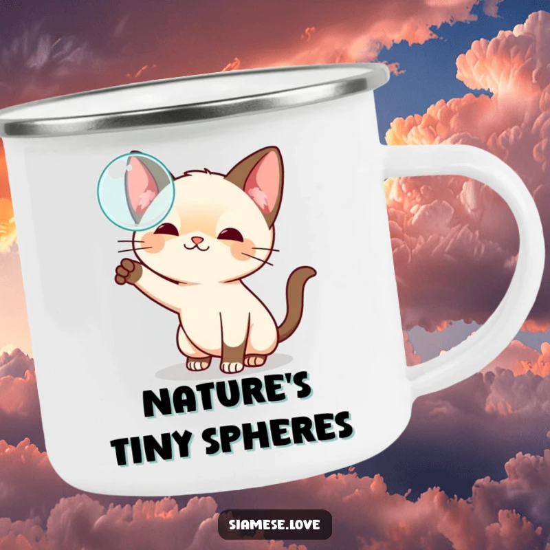 Funny kawaii Siamese cat camping mug, playfully swatting at a floating bubble, designed for outdoor fun and whimsy.