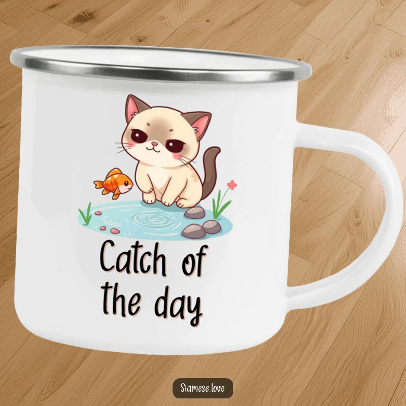 Funny Siamese cat camping mug, smugly catching a falling fish from a tiny pond, perfect for outdoor enthusiasts who love humor.