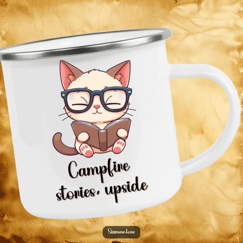 Funny Siamese cat camping mug of a feline in glasses reading a book upside down, designed for outdoor use and humor.