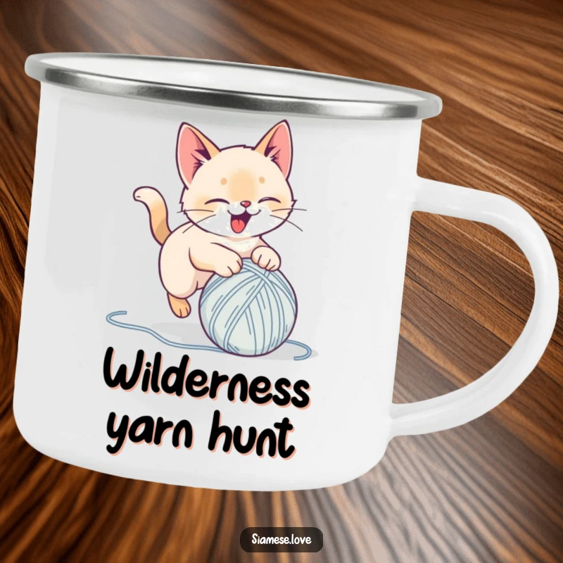 Funny camping mug with a stylized Siamese cat delightedly pouncing on a yarn ball, perfect for outdoor enthusiasts and humor lovers.