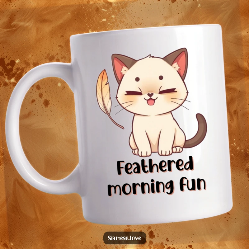 Funny cute Siamese cat mug with a mischievous grin, playfully batting at a colorful feather, capturing feline fun.