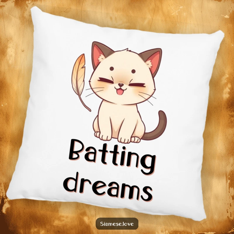 Funny cute Siamese cat pillow with a mischievous grin, batting at a feather, cozy and charming for ultimate relaxation.