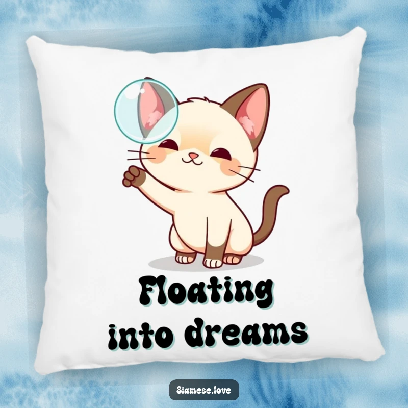 Funny kawaii Siamese cat pillow, playfully swatting at a floating bubble, offering soft comfort and whimsical delight.