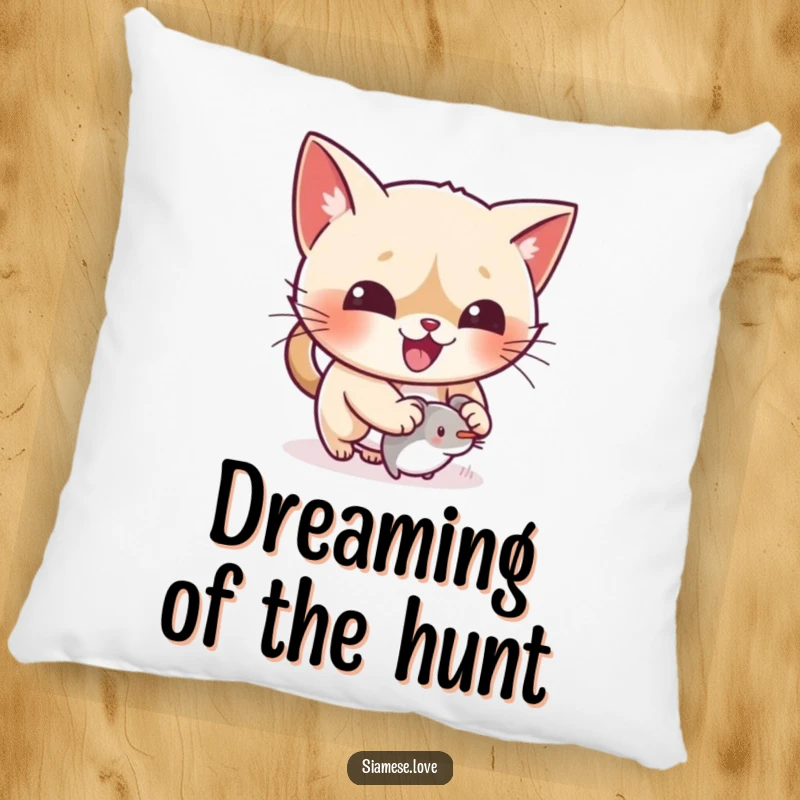 Funny kawaii Siamese cat pouncing on a tiny toy on a soft pillow, ideal for playful comfort.