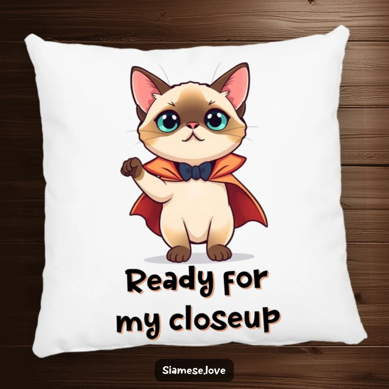 Funny Pillow: A Siamese cat in a tiny cape striking a theatrical pose, adding a touch of playful drama.