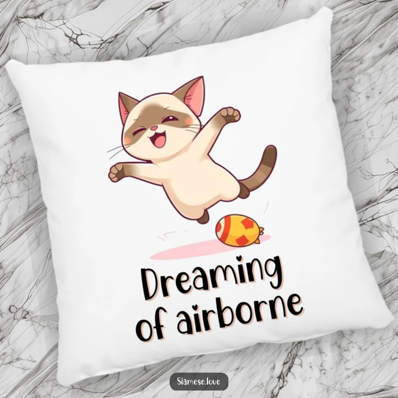Funny kawaii Siamese cat pillow, joyfully leaping for a toy, offering soft comfort and a dose of playful feline energy.
