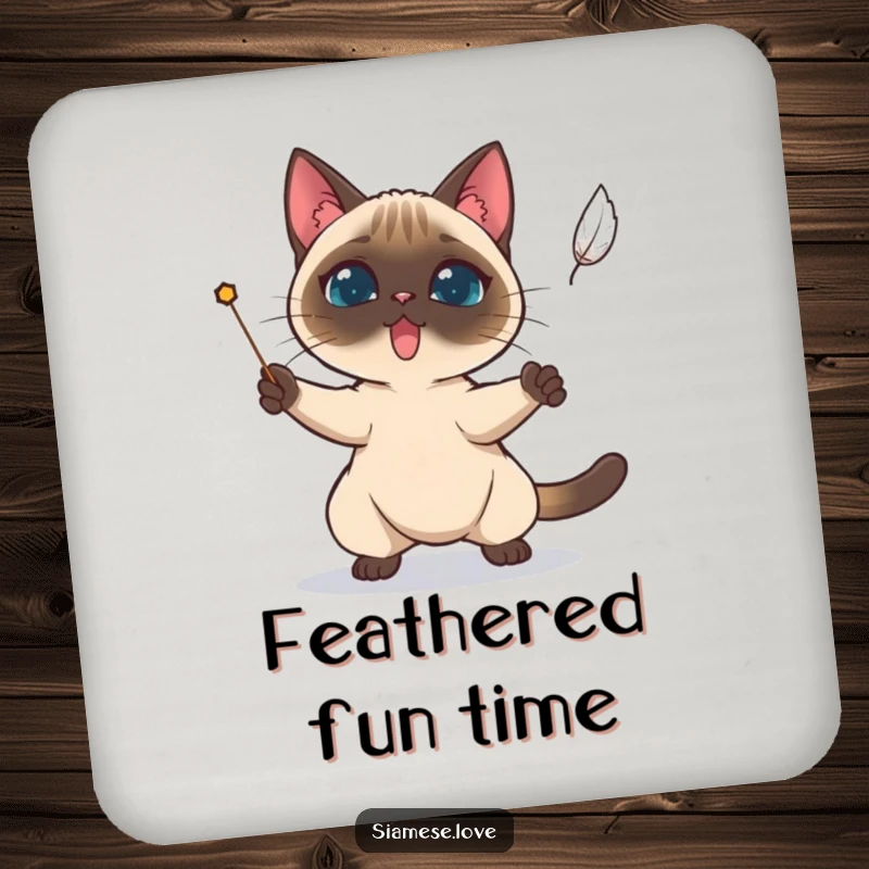 Funny Siamese cat determinedly trying to catch a falling feather on a drink coaster.