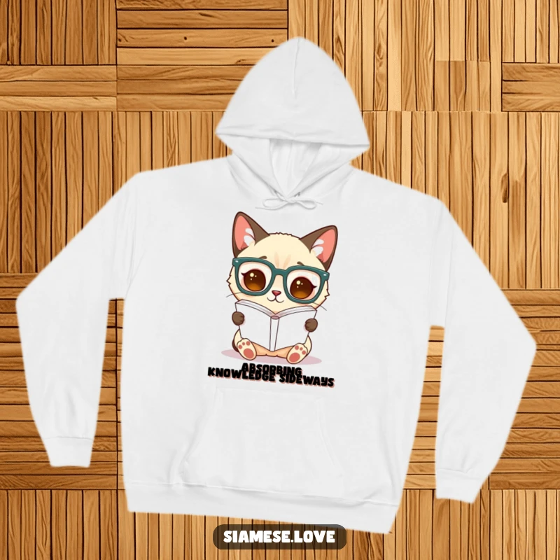 Funny Siamese cat hoodie, a cat in oversized glasses reads a book held upside down, blending wit and warmth.
