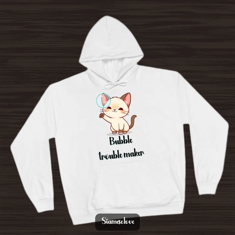 Funny kawaii Siamese cat hoodie, playfully swatting at a floating bubble, offering cozy comfort and whimsical charm.