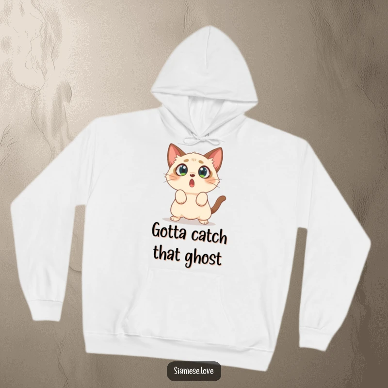Funny hoodie depicting a surprised Siamese cat with wide, startled eyes, comically pouncing at empty air.