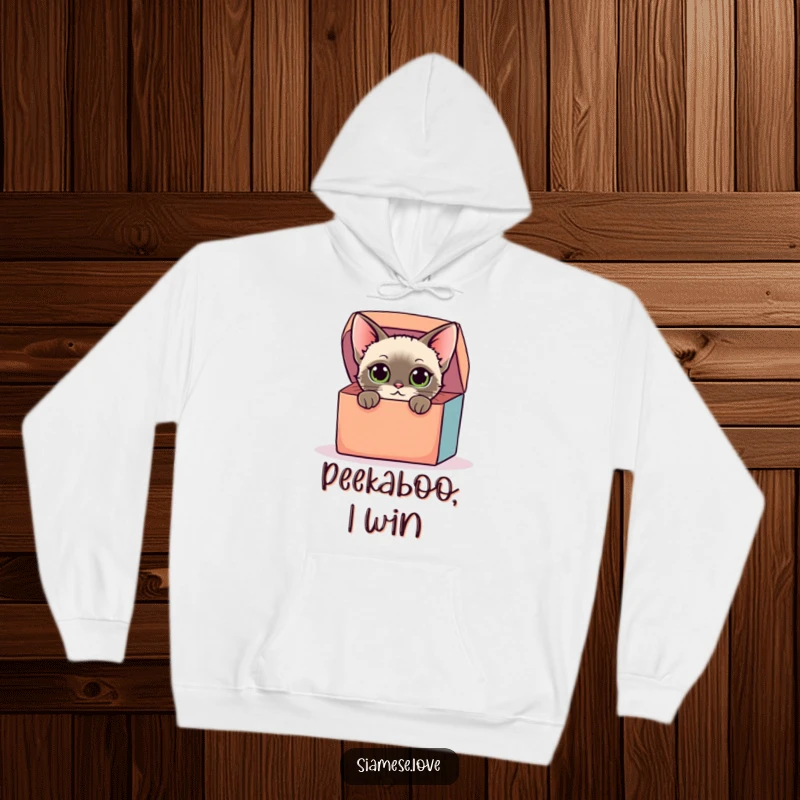 Funny hoodie featuring a stylized Siamese cat with curious eyes peeking from a colorful box, offering warmth and playful humor for a great gift.