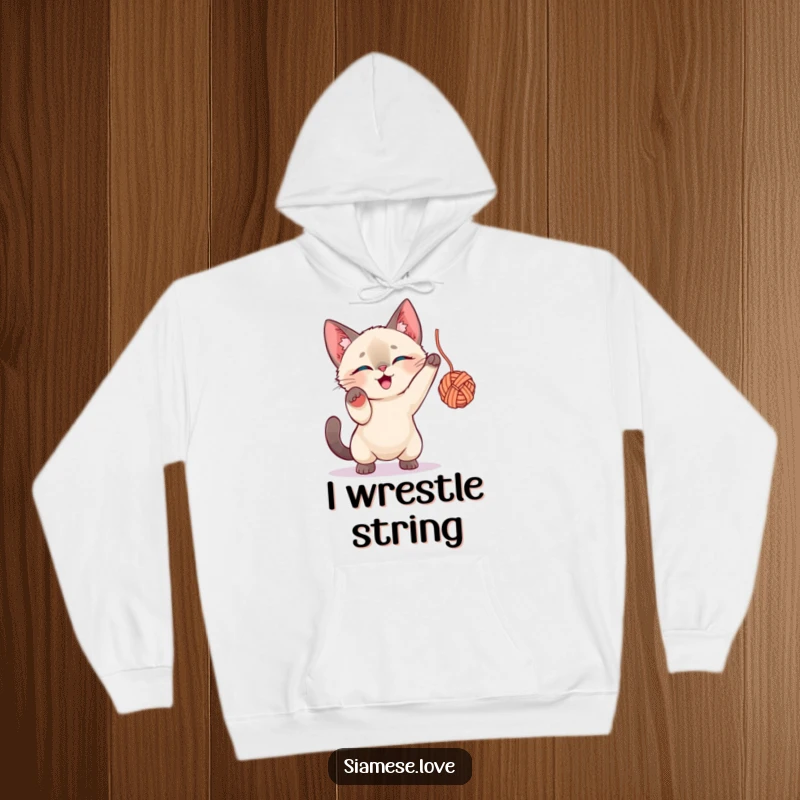 Funny Siamese Cat Hoodie: A joyful Siamese cat in mid-play, batting enthusiastically at a colorful yarn ball.