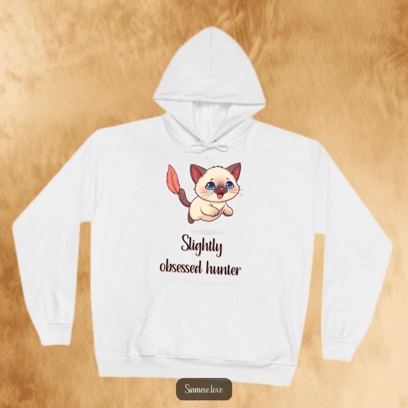 Funny Kawaii Siamese cat leaping after a feather toy, radiating playful energy on a soft, warm hoodie.
