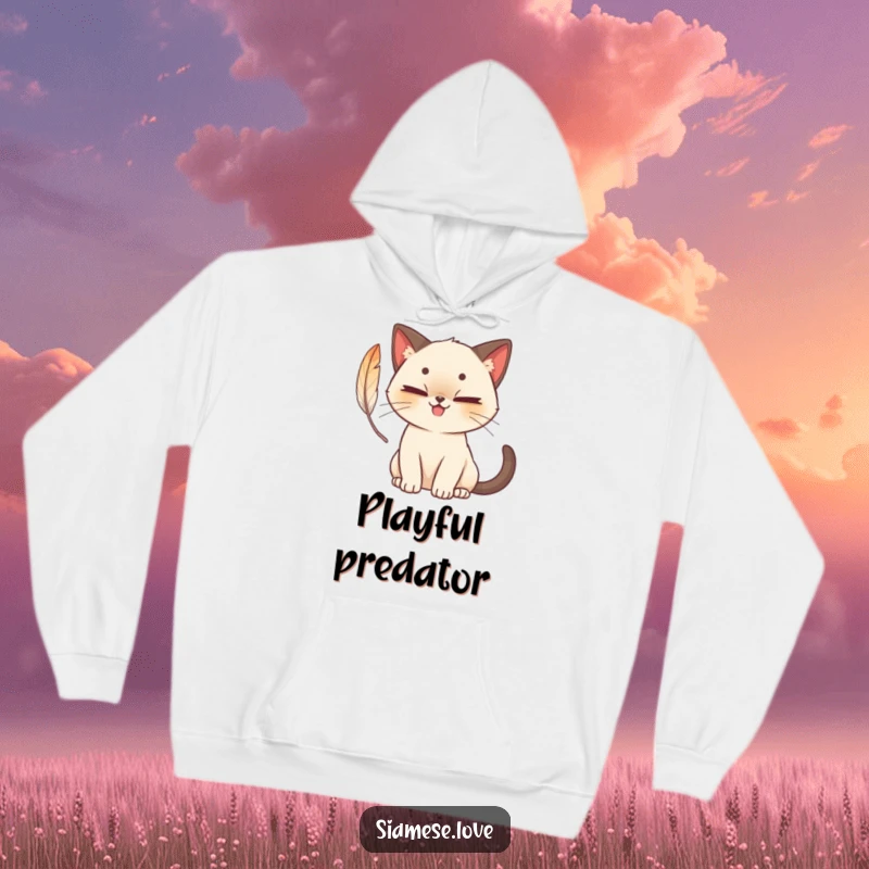 Funny cute Siamese cat hoodie with a mischievous grin, batting at a feather, cozy and playful for ultimate comfort.