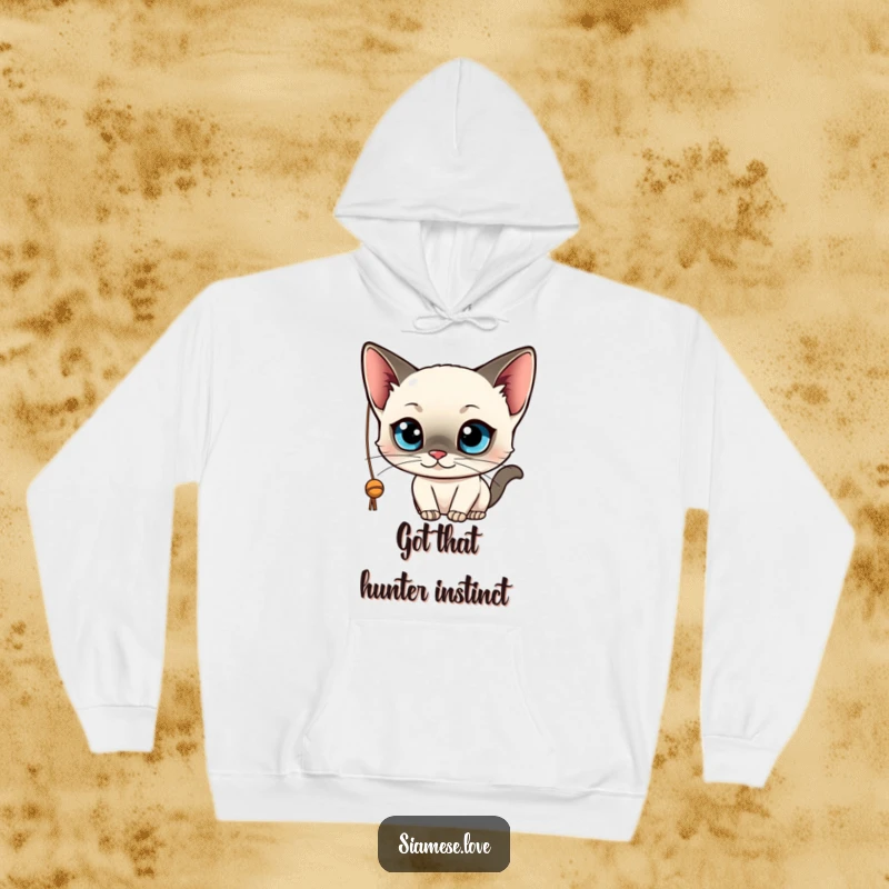 Funny and cozy hoodie featuring a kawaii Siamese cat with wide blue eyes, playfully engaged with a dangling string. Soft and cute.