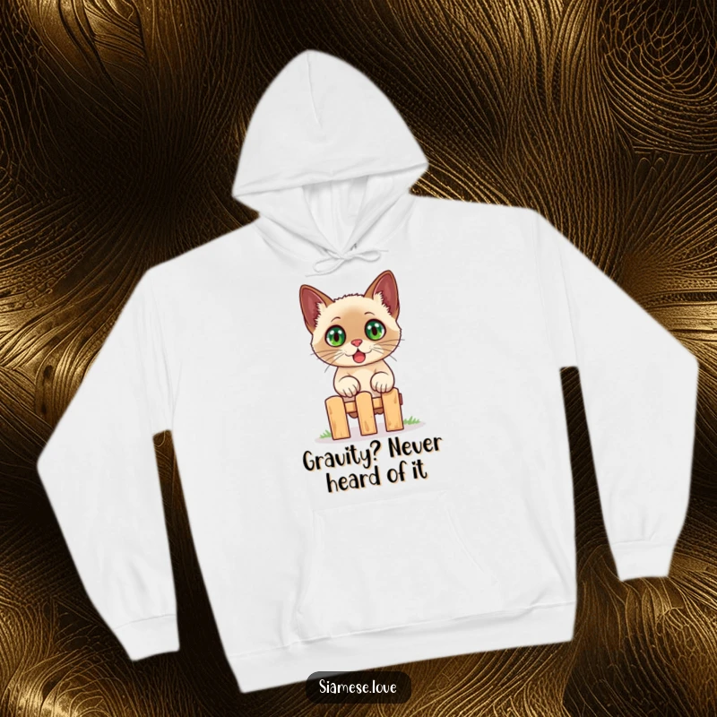 Funny Siamese cat hoodie, depicting a wide-eyed, surprised cat jumping over a small fence, designed for maximum humorous appeal.