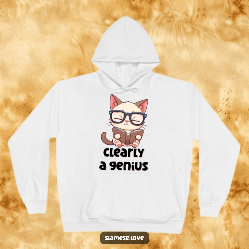 Funny Siamese cat hoodie featuring a studious feline in oversized glasses reading a book upside down, designed for warmth and wit.