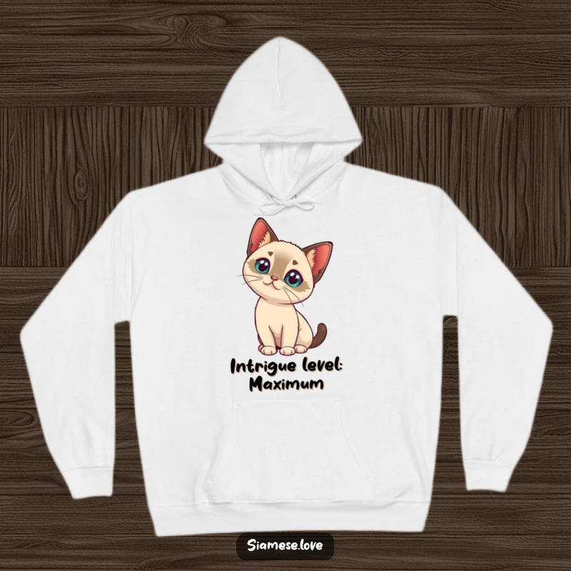 Funny kawaii Siamese cat tilting its head with intrigue on a warm hoodie, embodying cozy curiosity.