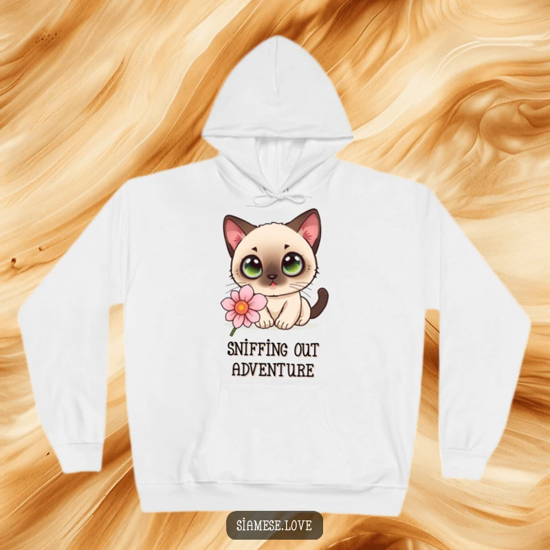 Funny kawaii Siamese cat with wide eyes sniffing a flower on a warm hoodie, radiating cozy curiosity.