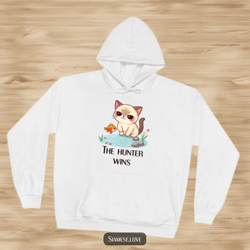 Funny Siamese cat hoodie, smugly catching a falling fish from a tiny pond, showcasing cunning and a hilarious, cozy feline moment.