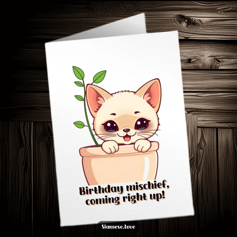 Funny Free Printable Birthday Card: Kawaii Siamese cat with mischievous grin peeking from behind a planter, playful.