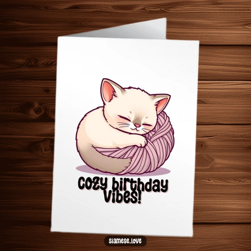 Cute Free Printable Birthday Card: A content Siamese cat peacefully curled up inside a large ball of yarn, looking cozy.