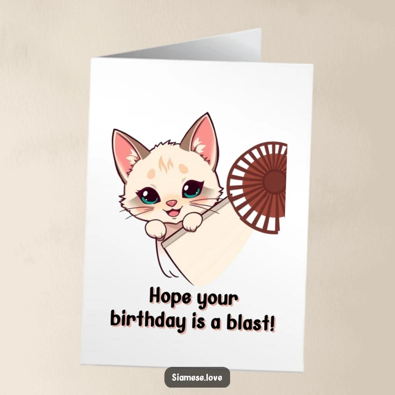 Funny Free Printable Birthday Card: Mischievous Siamese cat peeking from behind a giant fan with a cheeky grin, ready to surprise.