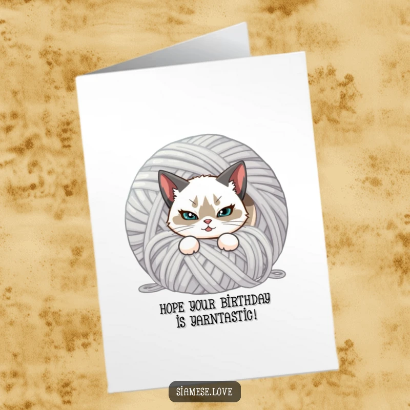 Funny Free Printable Birthday Card: Siamese cat with a smirk hiding behind yarn, celebrating a birthday.
