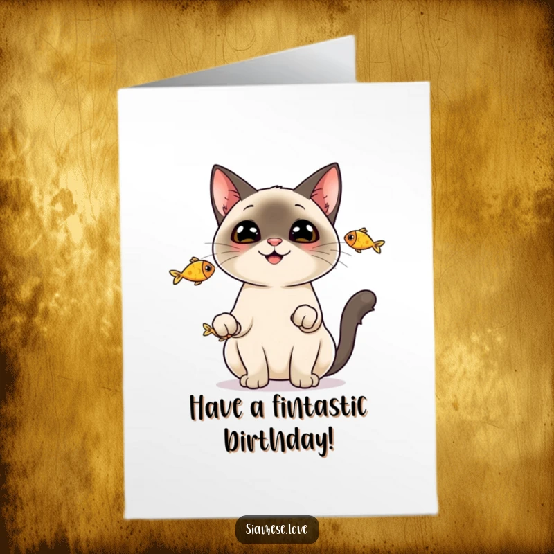 Funny Free Printable Birthday Card: a cheerful Siamese cat skillfully juggling three small, shiny fish with a big smile.