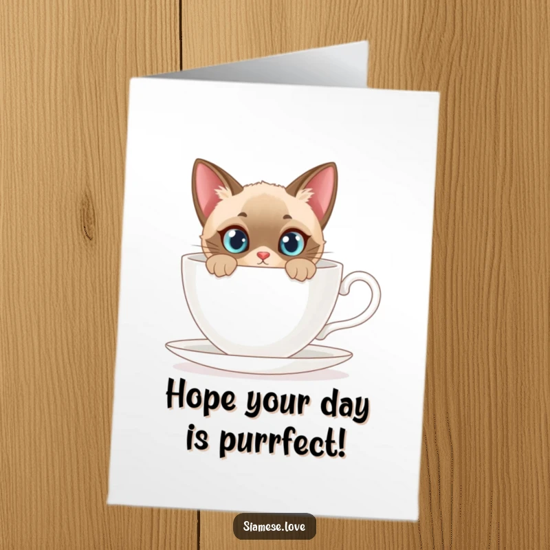 Funny Free Printable Birthday Card: A curious Siamese cat peeks from behind a giant teacup, wishing a happy birthday.