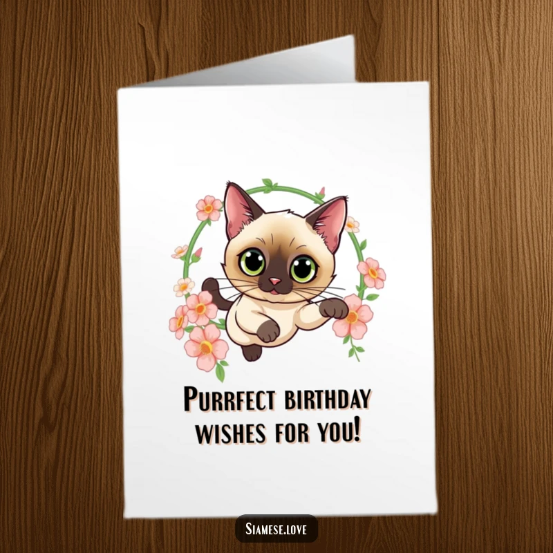 Funny Free Printable Birthday Card: Siamese cat with wide, curious eyes leaping gracefully through a hoop adorned with flowers.