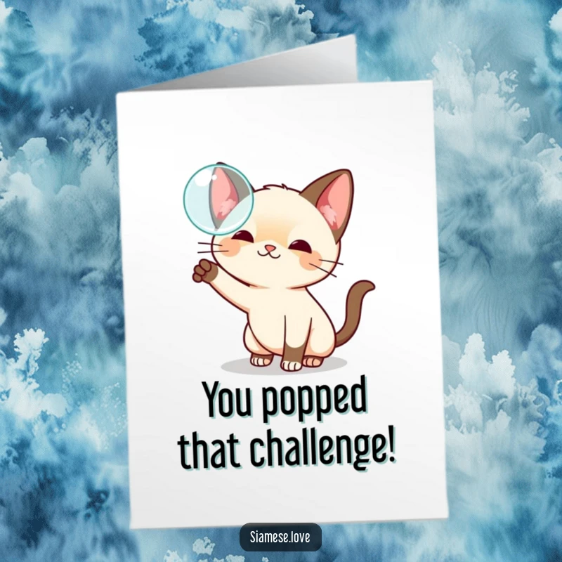 Funny Free Printable Congratulations Card featuring a playful kawaii Siamese cat swatting at a shimmering floating bubble with focus.