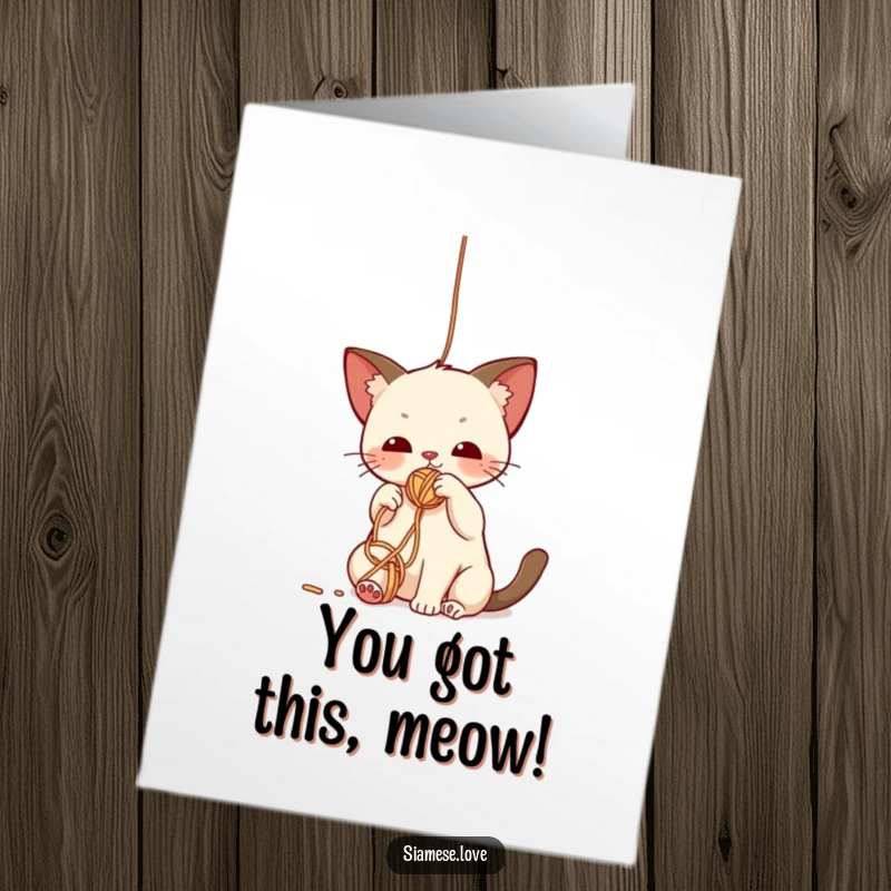 Free Printable Congratulations Card: Cute kawaii Siamese cat playfully batting its paw towards a bright, dangling ball of yarn.