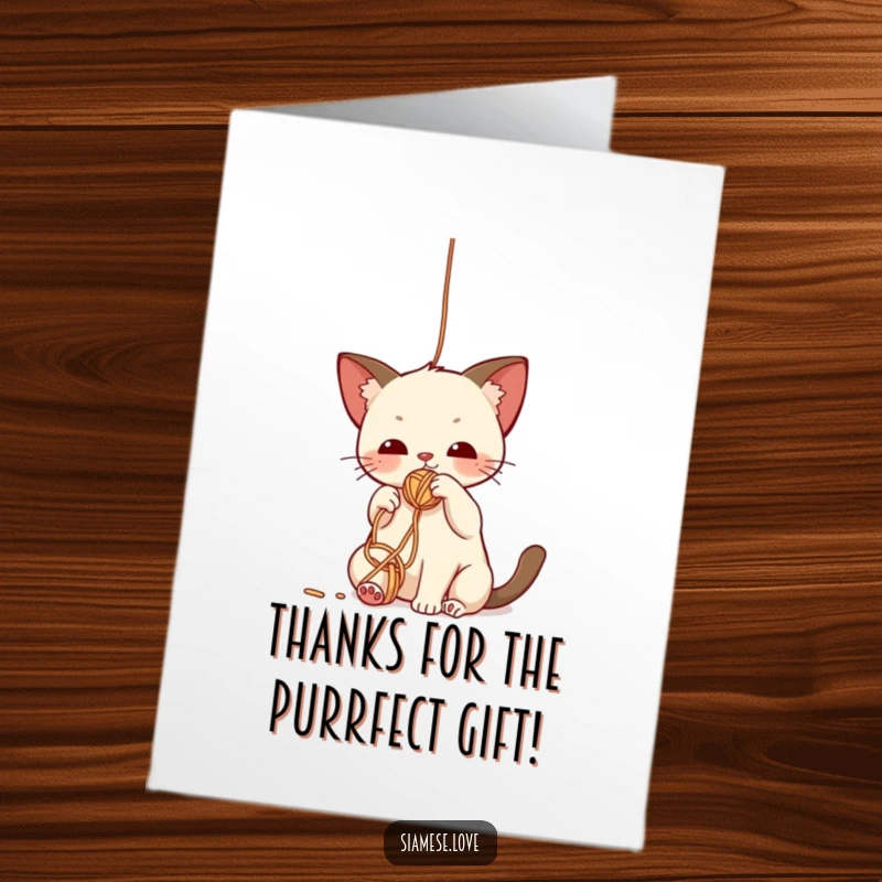 Funny Free Printable Thank You Card: A cute kawaii Siamese cat batting playfully at a fuzzy yarn ball on a string.
