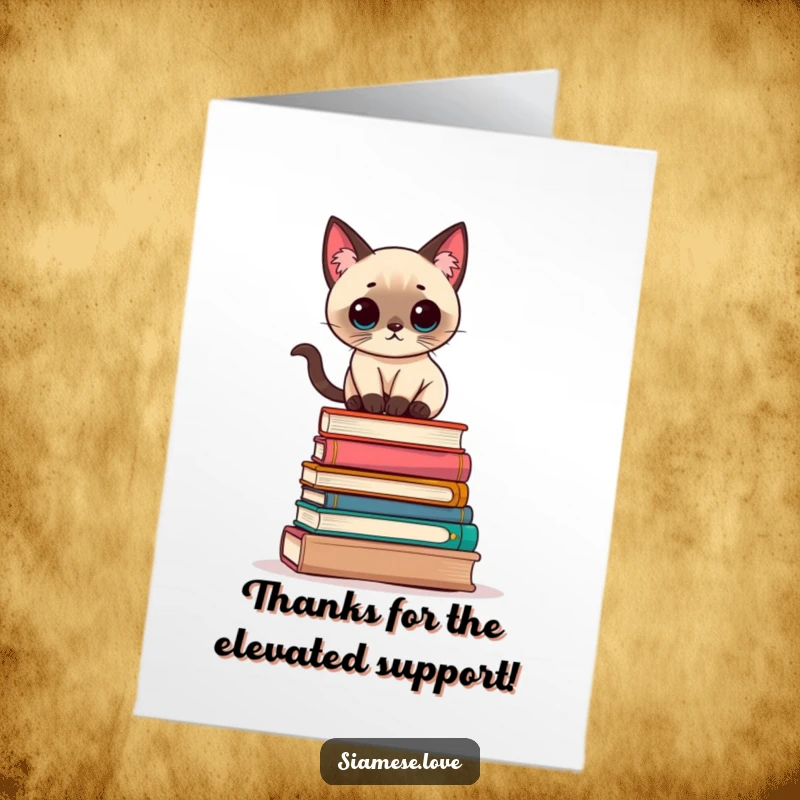 Free Printable Thank You Card: A Kawaii Siamese cat balances on books, expressing thanks with quirky charm.