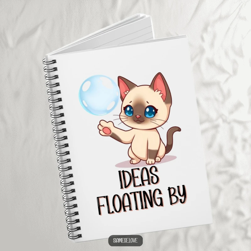 Funny Siamese cat batting a floating bubble on a notebook cover, perfect for creative notes.