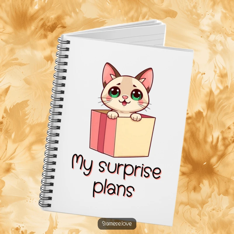 Funny Siamese cat emerging from a gift box with a surprised expression on a notebook cover, inspiring creative writing.
