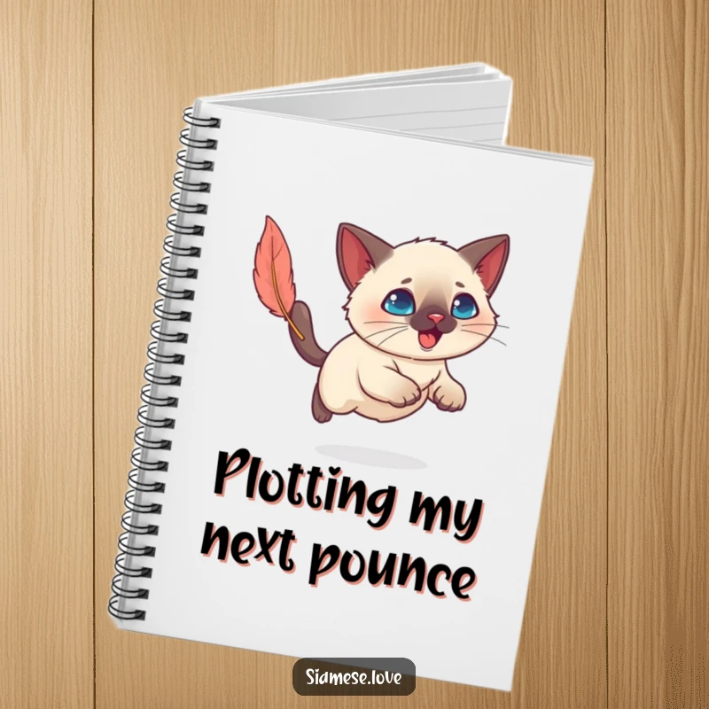 Funny Kawaii Siamese cat focused on a feather toy, ready to jot down notes, perfect for a humorous notebook.