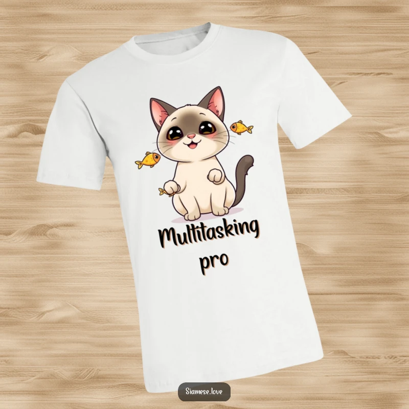 Funny T-Shirt: A cheerful Siamese cat expertly juggling three small fish, looking quite pleased with itself.
