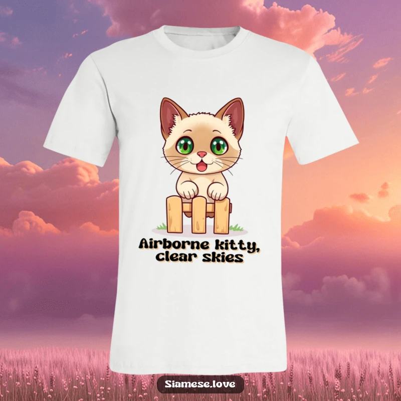 Funny Siamese cat t-shirt, a startled feline with wide eyes captured mid-jump over a miniature fence, expressing comical surprise and energy.