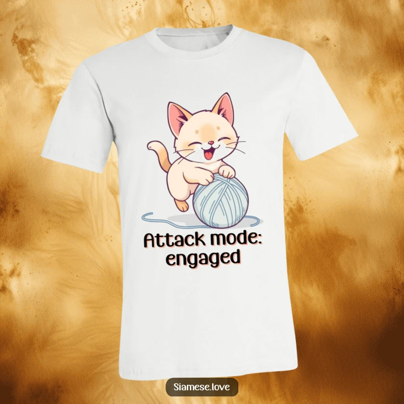 Funny t-shirt showing a stylized Siamese cat joyfully pouncing on a yarn ball, full of playful delight, ideal for a humorous gift.