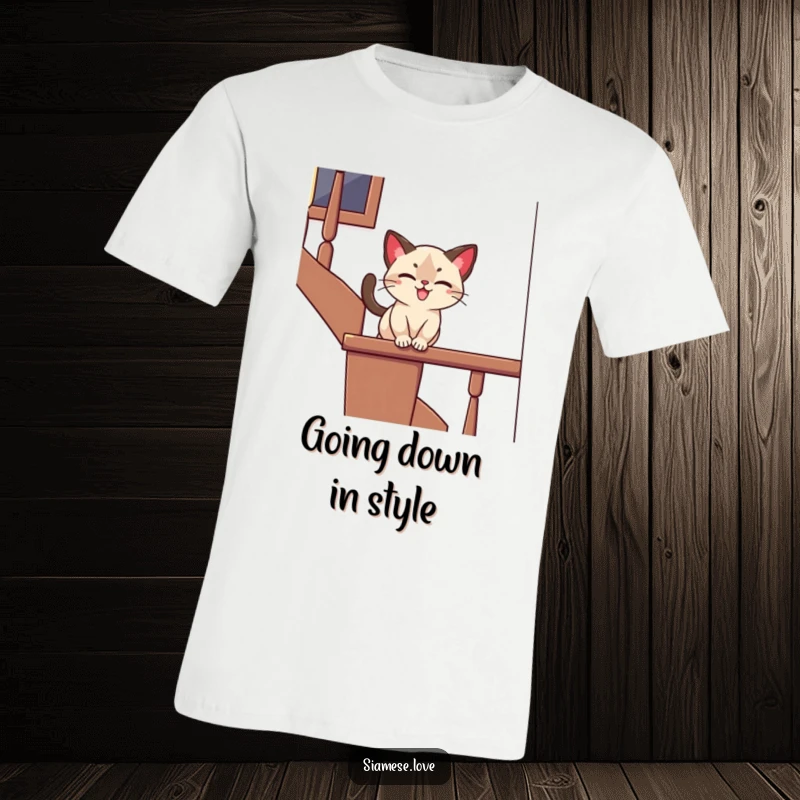 Funny t-shirt with a stylized Siamese cat playfully sliding down a banister with a joyful expression, perfect for a humorous gift.