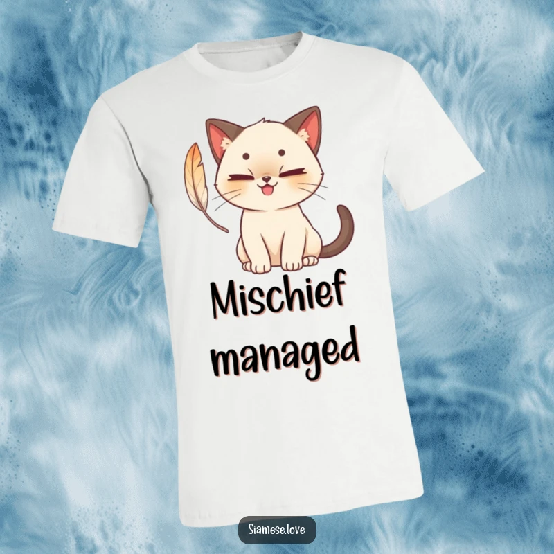 Funny cute Siamese cat t-shirt with a mischievous grin, batting playfully at a feather, evoking feline antics and humor.